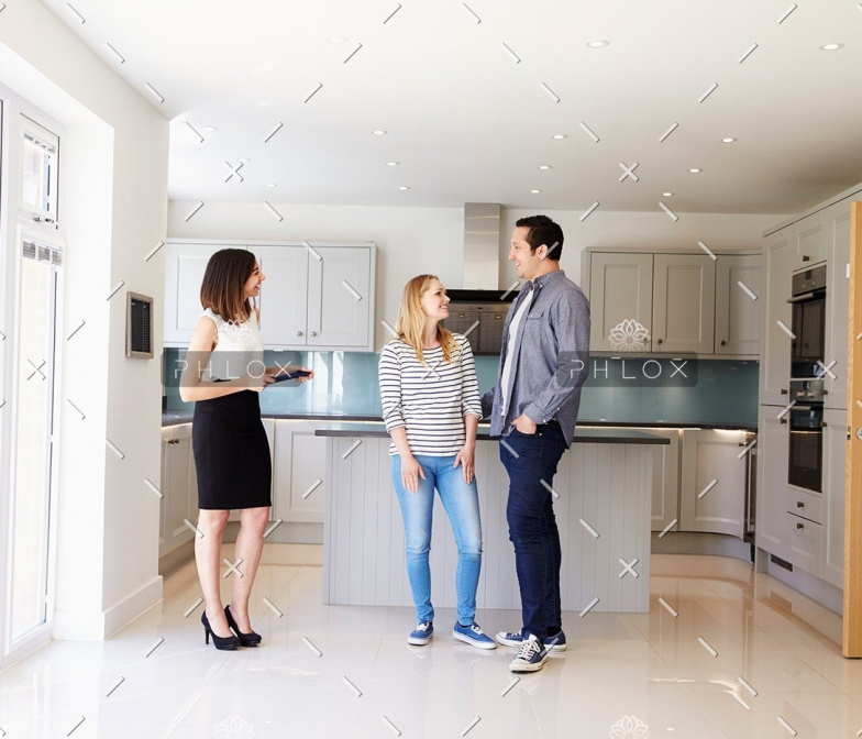 demo-attachment-103-realtor-showing-young-couple-around-property-for-PDHK2DX